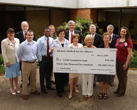 Scholarship recipients and representatives of the colleges of Medicine, Nursing and Health Related Professions join UAMS Chancellor I. Dodd Wilson, M.D., and John Blohm, UAMS vice chancellor for development and alumni affairs, in receiving a $94,500 check from the Arkansas Medical Society Alliance to endow future scholarships.