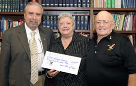 Conrad McKown, Arkansas state worthy president of the Fraternal Order of Eagles No. 60, and his wife, Georgianna, present Stavros Manolagas, M.D., Ph.D., with a $2,500 donation for diabetes research.