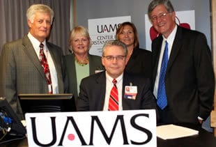 (From left) Lawrence Cornett, M.D., Debbie Fiser, M.D., Cindy Henrich and UAMS Chancellor I. Dodd Wilson with Curtis Lowery, M.D., (seated) after announcing UAMS’ largest ever research grant. 