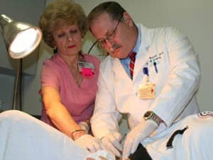 Keith Bennett, M.D., (right), and Mary Ann Dalmut, R.N., treat a patient at the new UAMS Wound Center.