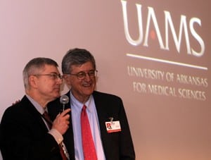 Richard Wheeler, M.D., of the College of Medicine, congratulates Wilson, his longtime colleague, during Wilson's final State of the Campus presentation.