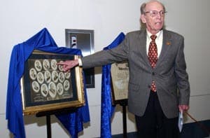 Roger Browning Bost, M.D., unveils a diploma and class photo from 1912 that he donated to the College of Pharmacy.