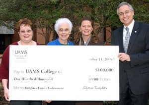 Kim Knighten Oelke and Sharon Harwood Knighten present a check for $100,000 to UAMS College of Nursing Dean Claudia Barone, Ph.D., R.N., and UAMS Chancellor Dan Rahn, M.D.