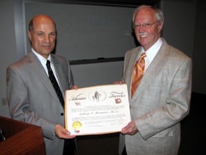 Anthony Mannarino, Ph.D. (left), accepts an Arkansas Traveler certificate from state Sen. Percy Malone, whose work in the Arkansas Legislature led to the creation of the AR BEST program.