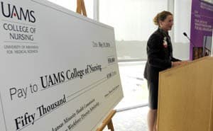 Claudia Barone, dean of the College of Nursing, accepts a $50,000 gift from the Arkansas Minority Health Commission. 