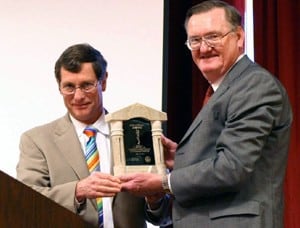 Whit Hall, M.D., (left) is presented the Arkansas Medical Society’s Asklepion Award by Michael Moody, M.D.