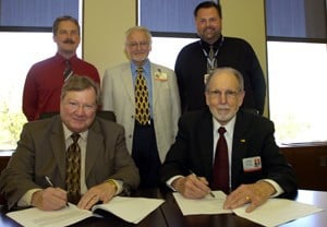 (Seated) CHRP Dean Ronald Winters, Ph.D., (right) and Lyon College’s  John M. Peek; (standing from left) David Thomas, Ph.D., of Lyon College, UAMS AHEC North Central Director Dennis Moore, Pharm.D., and Don Simpson, Ph.D., M.P.H., chairman of the Department of Laboratory Sciences