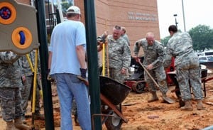 Members of the Arkansas National Guard and volunteers from the Psychiatric Research Institute construct a playground that will be used by patients of the psychiatric facility’s children’s inpatient unit.