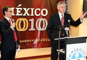 UAMS Chancellor Dan Rahn, M.D., speaks while the Mexican Consulate's Oscar Mora translates at the ribbon cutting of the Ventanilla de Salud. 