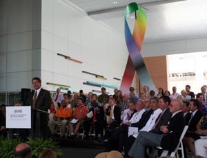 Dr. Peter Emanuel, Cancer Institute director, speaks at the dedication of the 300,000-square-foot addition, flanked by cancer survivors representing a cross section of patients treated at the facility.