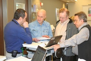 Bart Barlogie, M.D., Ph.D., (second from left) is currently leading research into why multiple myeloma is more aggressive for some patients. Here he confers with UAMS colleagues (from left) Elias Kiwan, M.D.; Frits van Rhee, M.D., Ph..D.; and Elias Anaissie, M.D.