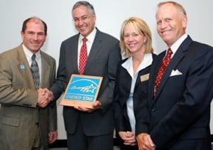 Clark Reed of the EPA (left) presents the ENERGY STAR designation to Dan Rahn, Ann Kemp, UA System vice president for administration, and Jim von Gremp.
