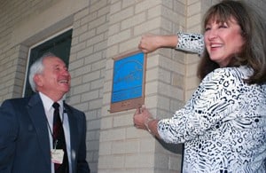 Larry Milne, Ph.D., vice chancellor for academic affairs and research, and Cheri Goforth, director of student activities, place the ENERGY STAR plaque on the UAMS Residence Hall.