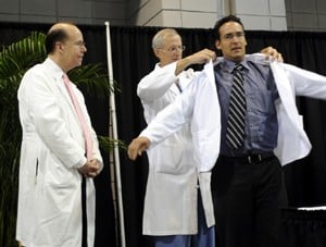 An incoming freshman medical student receives the white physician coat.