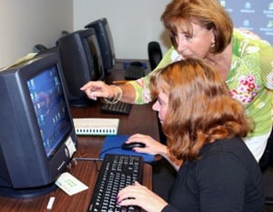 Doris Davis coaches Phyllis Ruocco during a computer class at the Institute on Aging.