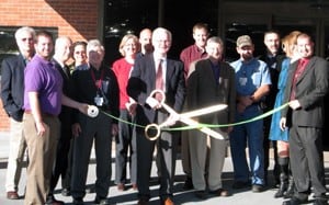 Fayetteville Chamber of Commerce members join UAMS Northwest staff to cut a green ribbon symbolizing the campus’ certification with the chamber’s “GreeNWAy” program for using energy-efficient and sustainable practices.