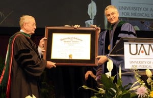 Fred W. Smith (left), chairman of the Donald W. Reynolds Foundation Board of Trustees, receives an honorary doctorate during graduation ceremonies May 21 in recognition of his longtime support of UAMS.