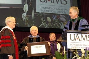 B. Alan Sugg, Ph.D., (left) longtime president of the University of Arkansas System who is retiring this year, receives the Chancellor's Award for Distinguished Service during graduation ceremonies in recognition of his support of UAMS.