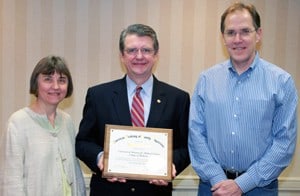 UAMS’ Jamie Howard, M.D., (left) and Daniel Knight, M.D., (right), with Roland Goertz, M.D., AAFP president, during a ceremony recognizing UAMS as a top producer of family medicine physicians.