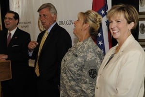 UAMS’ Becky Hall (far right), shares a laugh with (l-r), Chris Masingill, Gov. Mike Beebe and Col. Michele Cianci during a news conference announcing the Delta medical mission. 