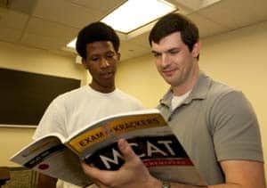 Brandon Booth, a student at Philander Smith College in Little Rock, (left) reviews material with COM student volunteer Chris Purnell of Jonesboro.