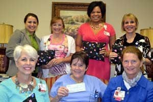 Displaying the breast cancer pillows are representatives of the UAMS Winthrop P. Rockefeller Cancer Institute and the UAMS College of Nursing: (back row) Cynthia Gregory; Kelly Pollnow; Roberta Clark; Maureen Smith, R.N.; (front row) Robin Dean; V. Suzanne Klimberg, M.D.; and Claudia Barone, R.N.