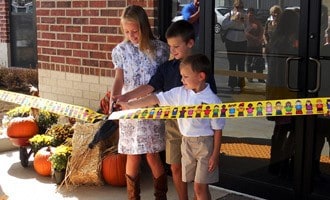 Three of Dr. Fiser’s grandchildren cut the ribbon to open the new KIDS FIRST Morrilton dedicated in his memory.