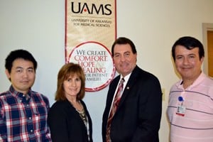 David Miller, UAMS chief information officer, (second from right) joins members of the IT team who worked on the clinical trial management program, (from left) Jiang Bian, Ph.D., Cheryl Lane and Umit Topaloglu, Ph.D.
