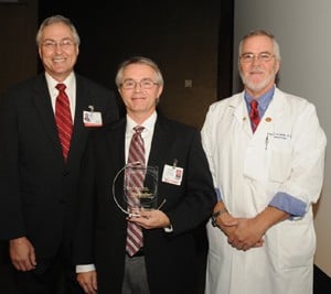 Chancellor Rahn and Graduate School Dean Robert McGehee, Ph.D., with award recipient Kevin Raney, Ph.D.