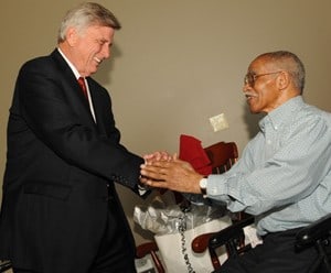Gov. Mike Beebe greets Charles White at an event honoring White.