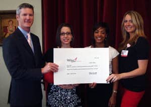 Mike Gavigan, Susan G. Komen for the Cure grants chairman, presents funding in support of the UAMS MammoVan to Heather Buie, Shannon Strickland and Stephanie McLean.