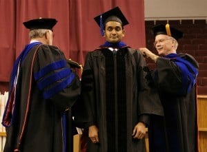 Lakshmi Prasad Potluri of India receives his doctorate from UAMS Graduate School Dean Robert McGehee, Ph.D. (left) and Kevin Young, Ph.D., a professor in the Department of Microbiology and Immunology, during UAMS commencement.