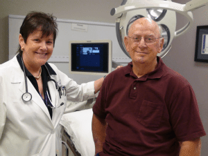 V. Suzanne Klimberg, M.D., stands beside Gerry Vickers, a patient she diagnosed with male breast cancer.