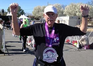 Jim Brown shows off his medal from completing the Little Rock Marathon in March, his first full marathon. 