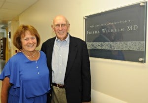 Frieda Wilhelm’s nephew David Gruenewald and his wife Alice, a retired laboratory scientist, pose with the plaque honoring Dr. Wilhelm’s gift to UAMS and naming the hospital’s surgical pathology lab for her.