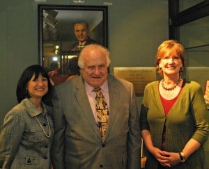Sandy McMath (center), son of Sid McMath pauses for a photo with College of Pharmacy Dean Stephanie Gardner (left) and College of Nursing Dean Lorraine Fraizer in front of a portrait of McMath's father, the late former governor of Arkansas.