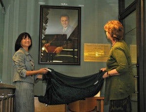 College of Pharmacy Dean Stephanie Gardner (left) and College of Nursing Dean Lorraine Fraizer uncover a portrait of late former Arkansas Gov. Sid McMath now hanging in the UAMS History Center in the Central Building. McMath lobbied successfully for a cigarette tax in the 1950s that funded construction of UAMS in its current location on Markham Street. He also supported the creation of the colleges of Nursing and Pharmacy in the early 1950s. 