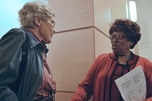 Dr. Elders speaks with retired physician Betty Lowe