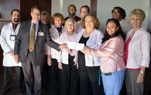 Members of Ashley County Cares present a donation to (front row from left) Issam Makhoul, M.D., Peter Emanuel, M.D., and Ronda Henry-Tillman, M.D.