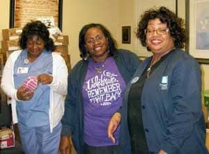 UAMS volunteers Pat Wright, Dee carter and Dianne Dotson shoes at River City Ministry to be given to the homeless.