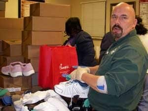 Vince Mann of Snell Orthotics gets ready to fit clients with new socks and shoes as part of Soles 4 Souls.
