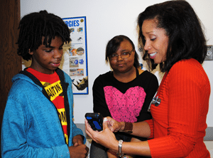 Tamara Perry, M.D., demonstrates the asthma app to participants in her study. 