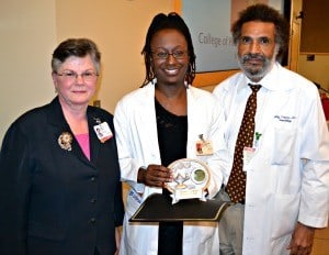 Creshelle Nash, M.D., (center) one of the 23 UAMS Phenomenal Women, is receives an award from Jeanne Heard, M.D., and Billy Thomas, M.D.