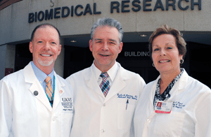 TRI Director Curtis Lowery, M.D. (center), authorized key aid to an effort by Philip Mayeux, Ph.D. (left), and Nancy Rusch, Ph.D., to earn the prestigious training grant.