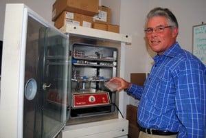 UAMS’ Richard Kurten, Ph.D., in his laboratory with living-lung samples kept in the incubator pictured, has increased the lifespan of the lung samples from about a week to six weeks, opening the door to new asthma research. 