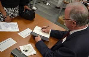 William D. Lindsey, Ph.D., signed books and thanked contributions from UAMS faculty and staff. 