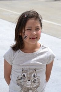 Katy Honda, daughter of UAMS' Jennifer Honda, pauses in the festivities to smile for the camera.