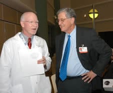 UAMS Chancellor I. Dodd Wilson talks with John Crow, Ph.D., director of the ALS Research Center. 