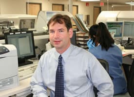 Joshua Bornhorst, Ph.D., shown here in the UAMS clinical lab, recently received the Young Investigator Award from the American Association of Clinical Chemistry.