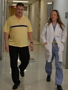 Just before a consultation, Wyrick and Watts walk down a hall in the UAMS Outpatient Center